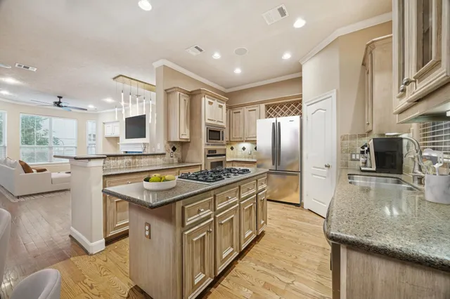 a hallway with white cabinets and wooden floor