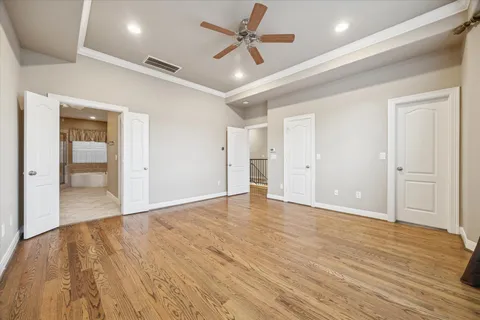 a view of an empty room and wooden floor