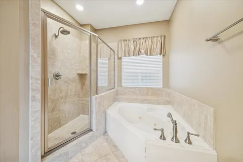 a bathroom with a bathtub and a shower