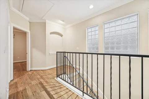 a view of a room with wooden floor and windows