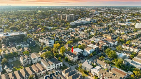 an aerial view of residential houses with city view
