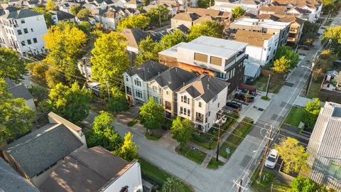 an aerial view of residential houses with yard