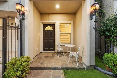 a view of balcony with two chairs and a potted plant