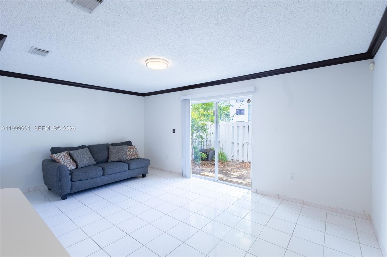 13874 Southwest 64th Street Miami, FL 33183 - Photo 14 of 25 a living room with furniture and a flat screen tv