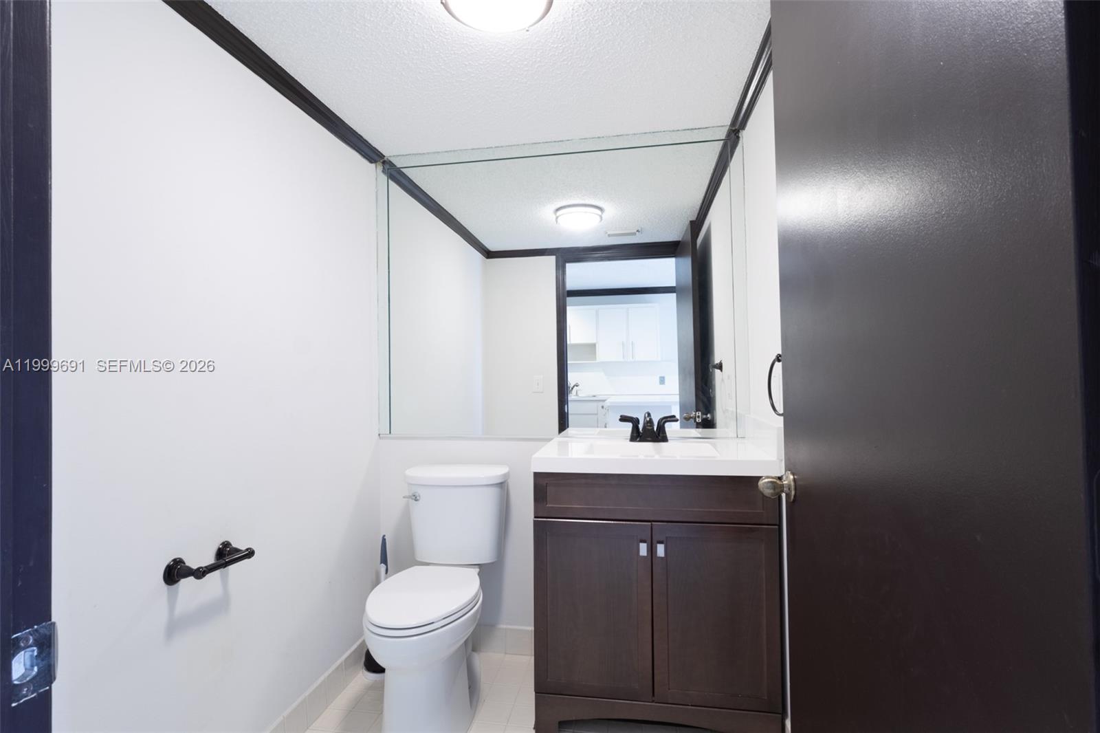 13874 Southwest 64th Street Miami, FL 33183 - Photo 17 of 25 a bathroom with a toilet sink and mirror