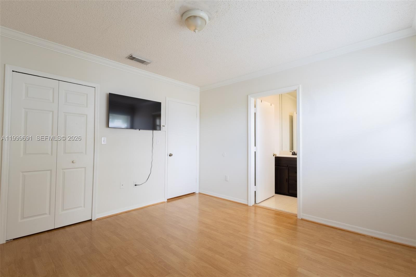 13874 Southwest 64th Street Miami, FL 33183 - Photo 20 of 25 an empty room with closet and a flat screen tv