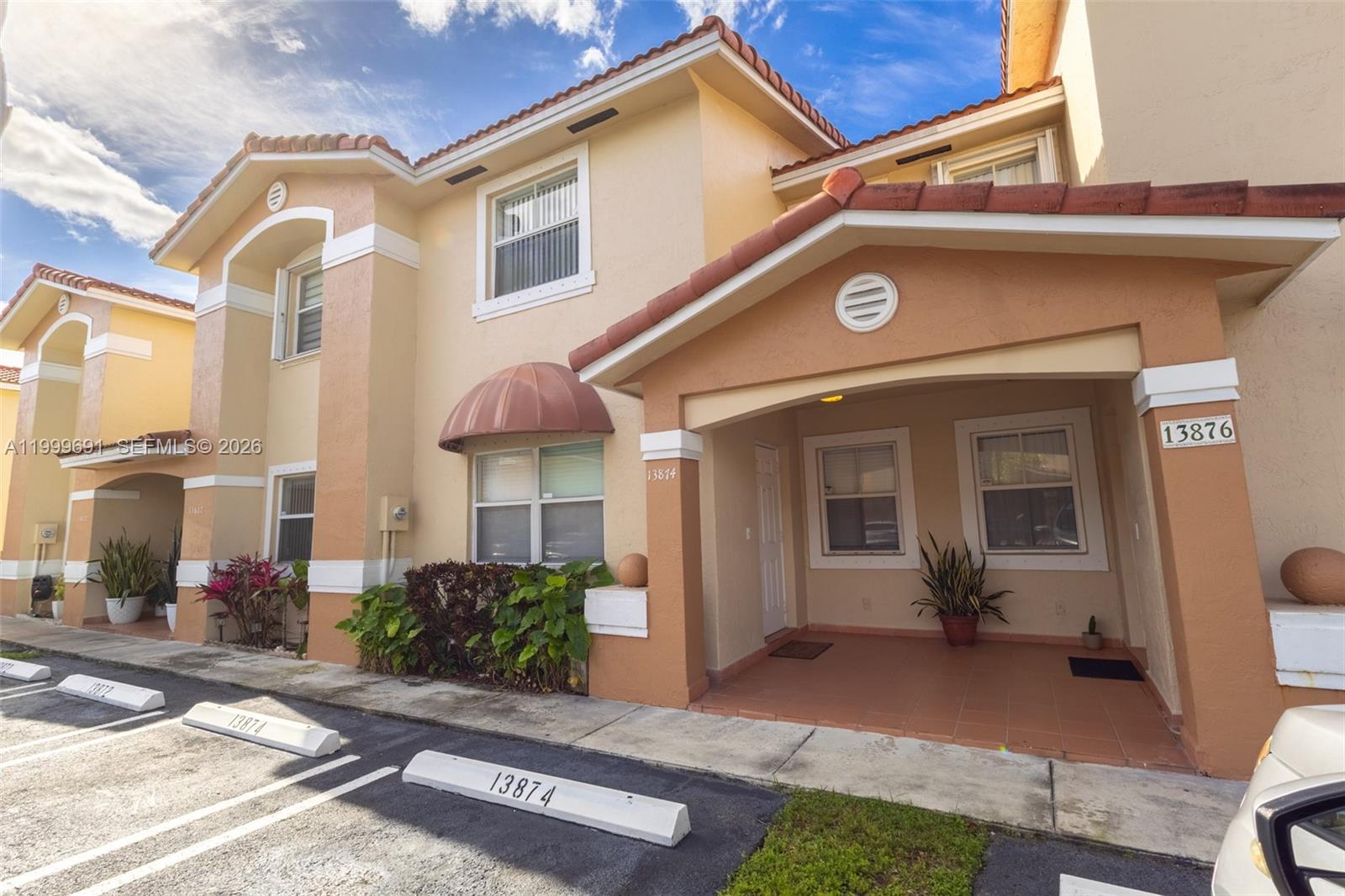 13874 Southwest 64th Street Miami, FL 33183 - Photo 2 of 25 a front view of a house with a yard