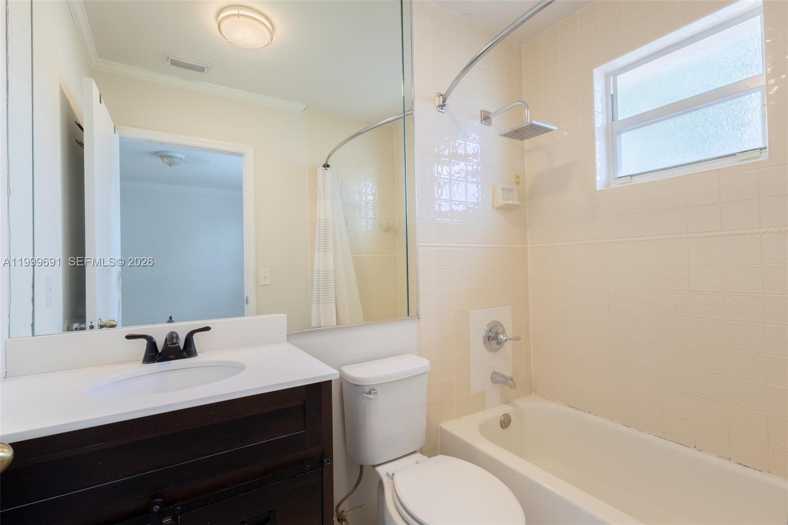 13874 Southwest 64th Street Miami, FL 33183 - Photo 22 of 25 a bathroom with a bathtub shower sink vanity mirror and toilet