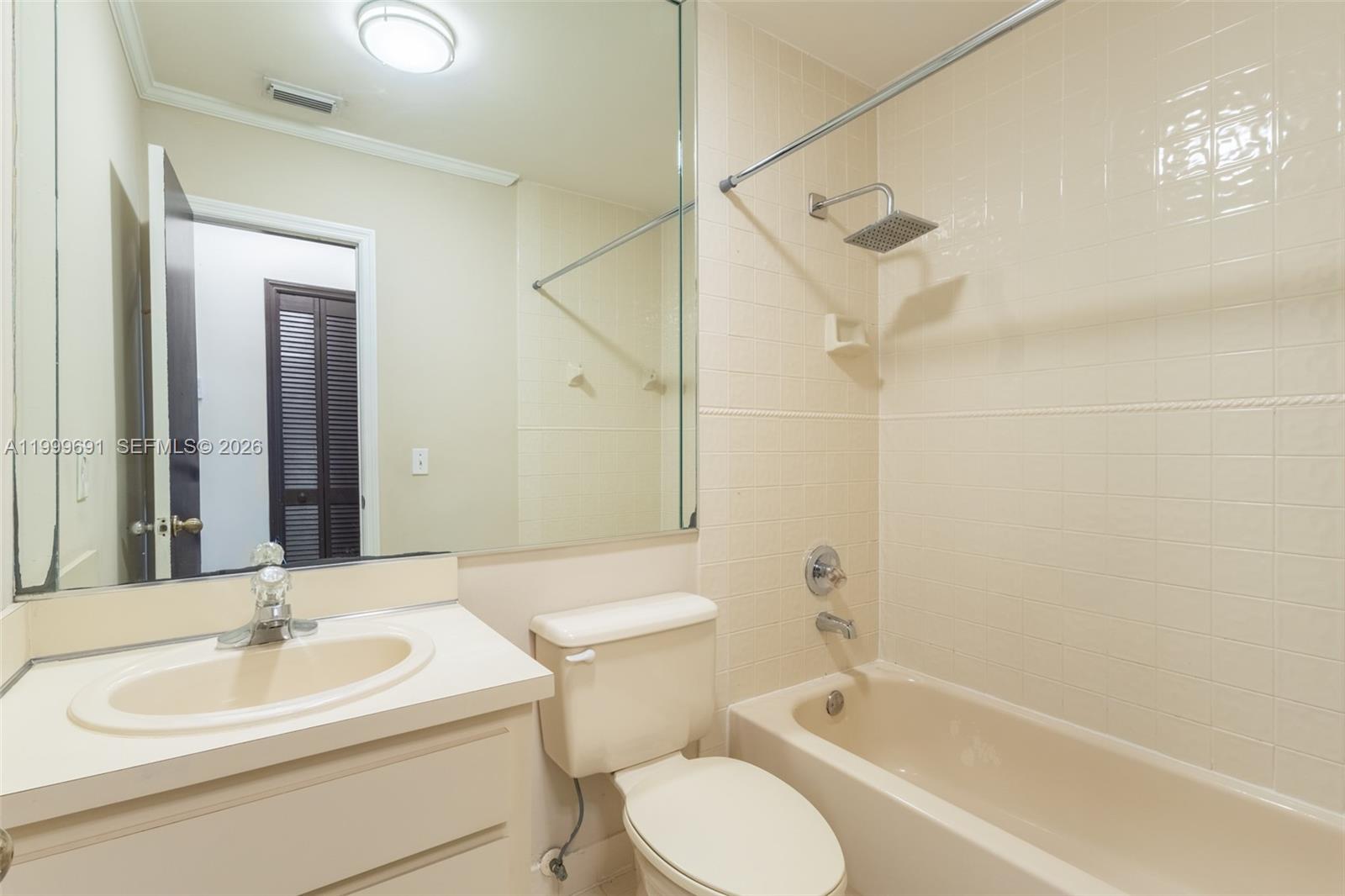 13874 Southwest 64th Street Miami, FL 33183 - Photo 23 of 25 a bathroom with a toilet sink vanity tub and mirror
