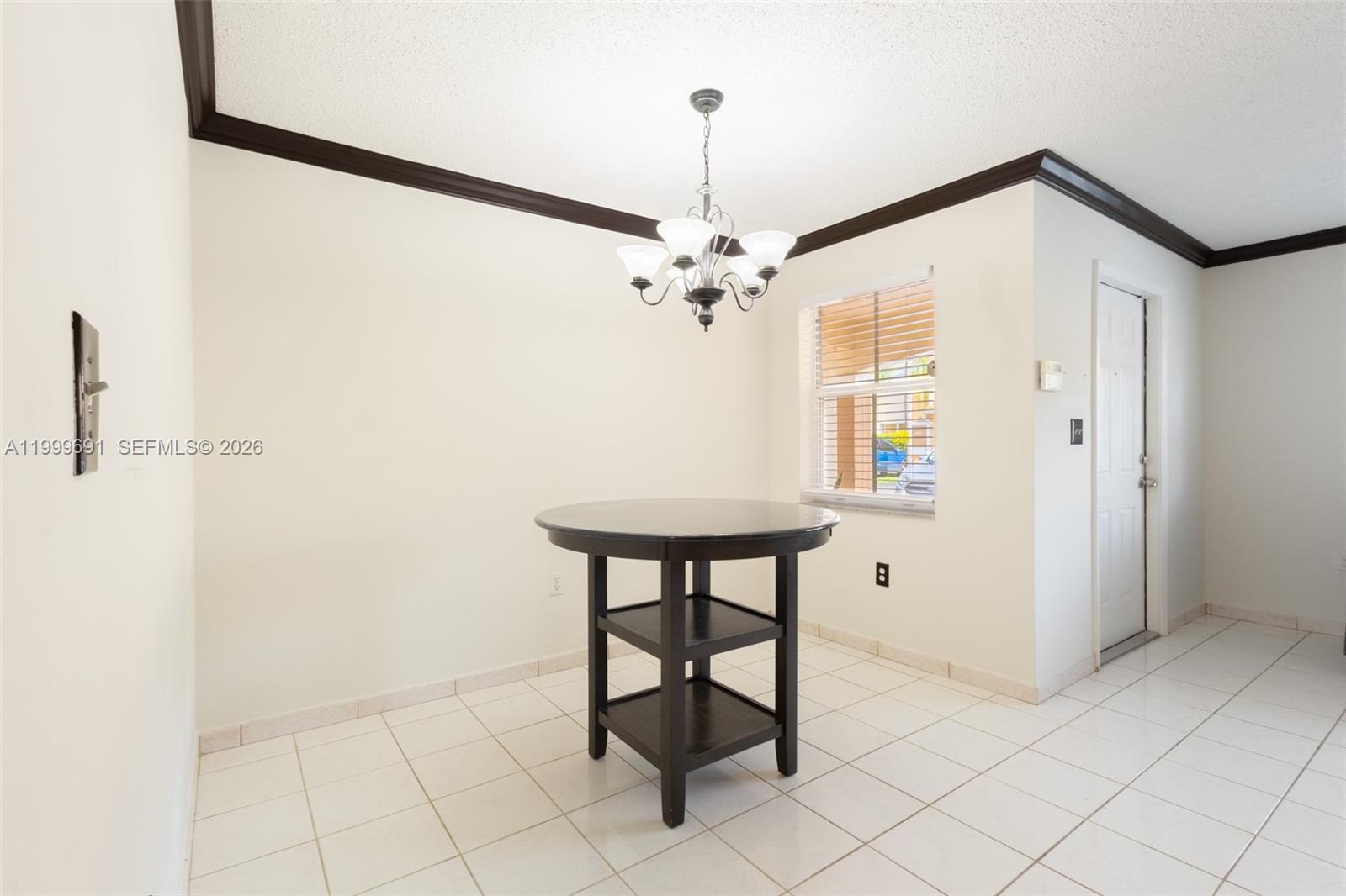 13874 Southwest 64th Street Miami, FL 33183 - Photo 7 of 25 a view of a hallway with a table and chairs