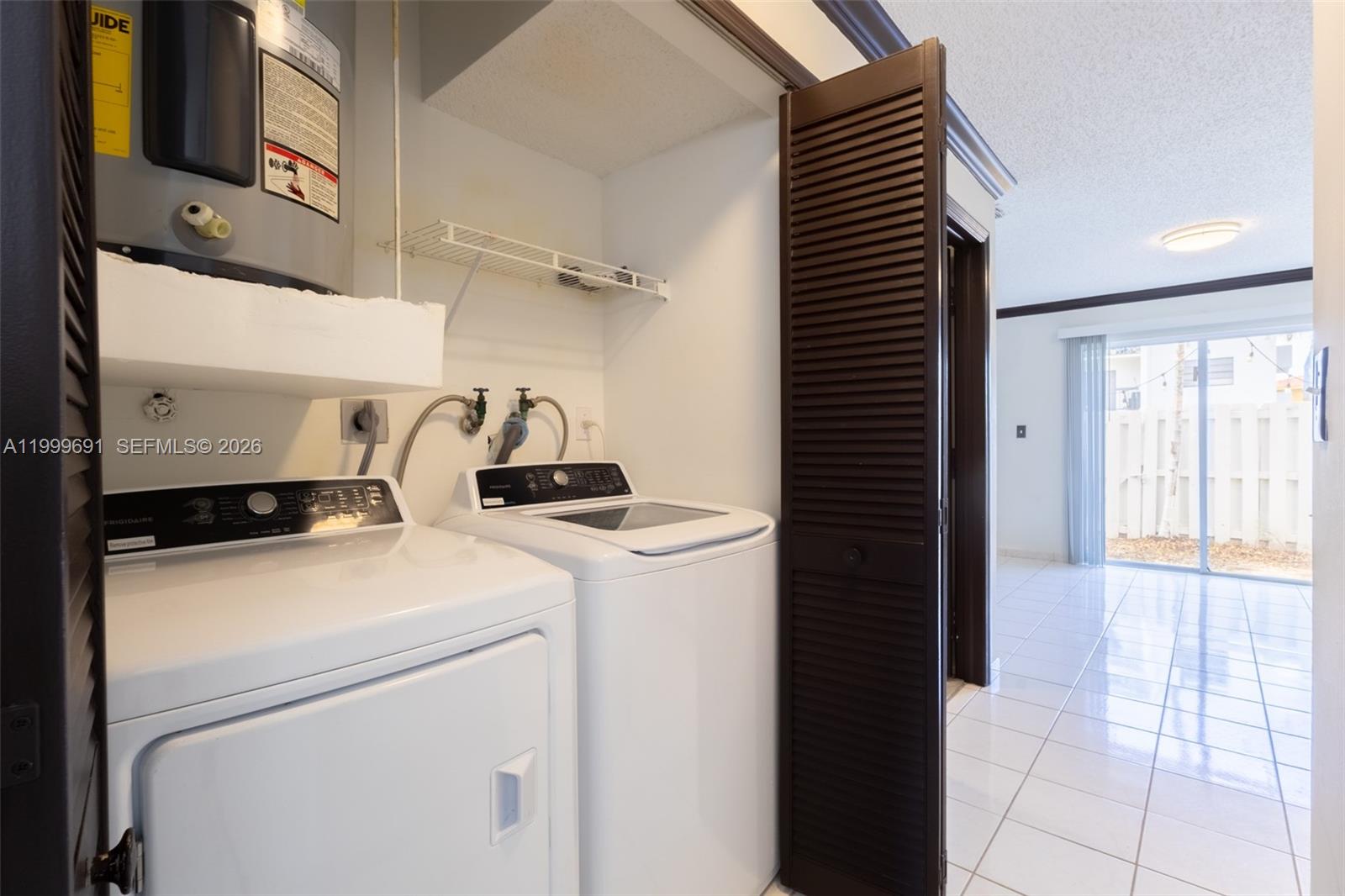 13874 Southwest 64th Street Miami, FL 33183 - Photo 8 of 25 a utility room with dryer and washer