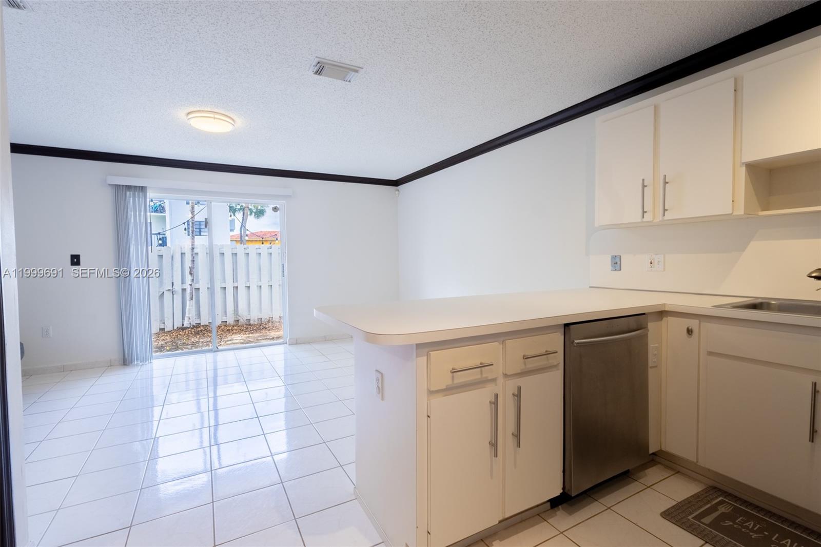 13874 Southwest 64th Street Miami, FL 33183 - Photo 9 of 25 a kitchen with a white cabinets and sink