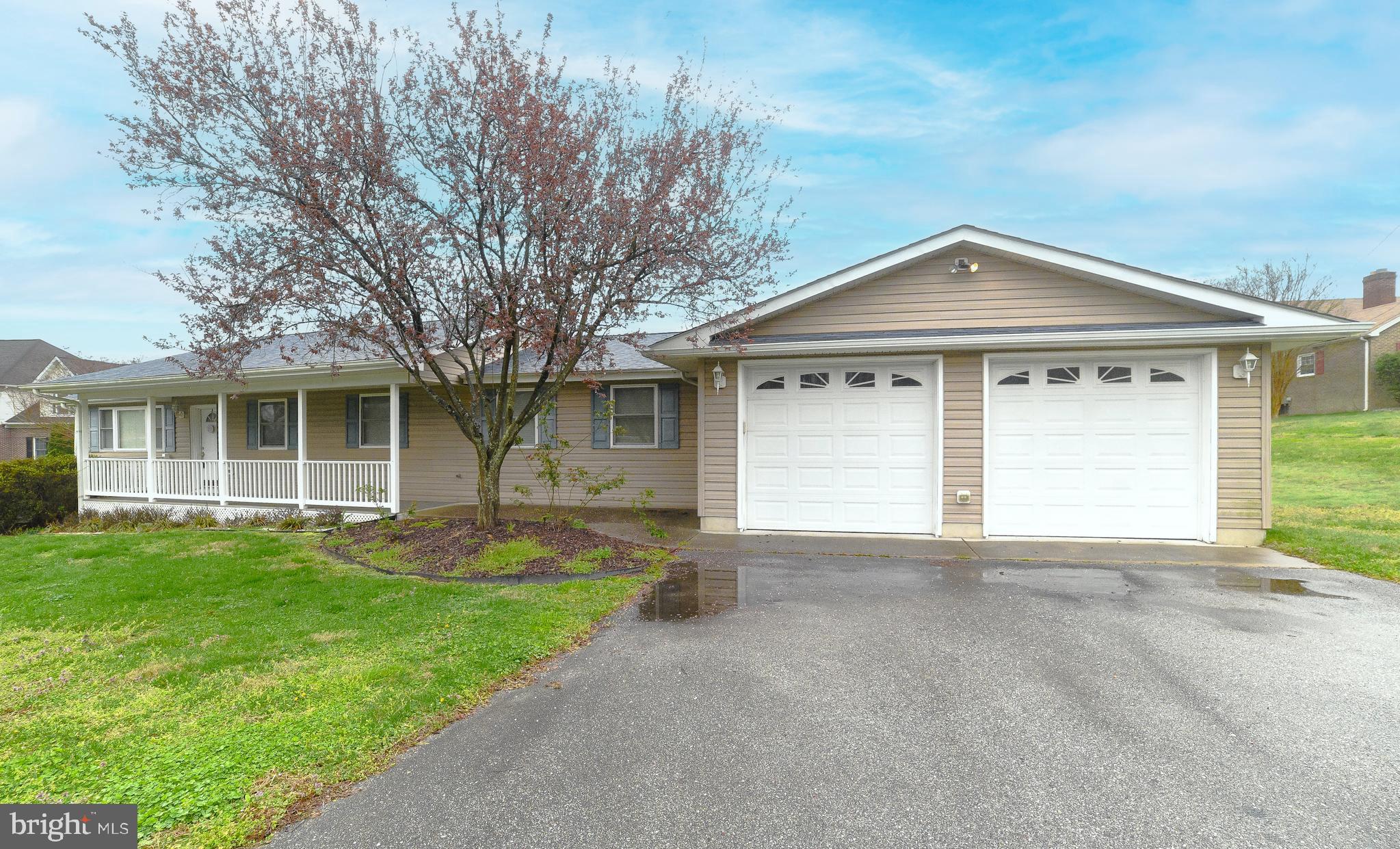 4485 Solomons Island Road Huntingtown, MD 20639 - Photo 11 of 46 a front view of a house with a garden and yard