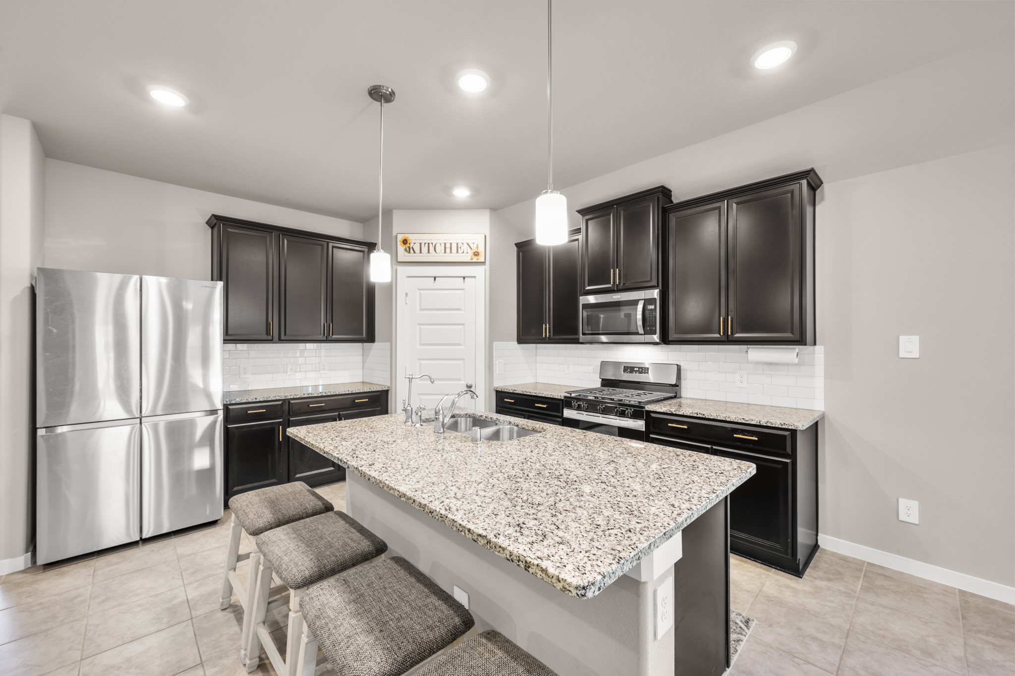 1326 Taft Pt Lane Rosharon, TX 77583 - Photo 12 of 39 a kitchen with a stove a refrigerator and a sink