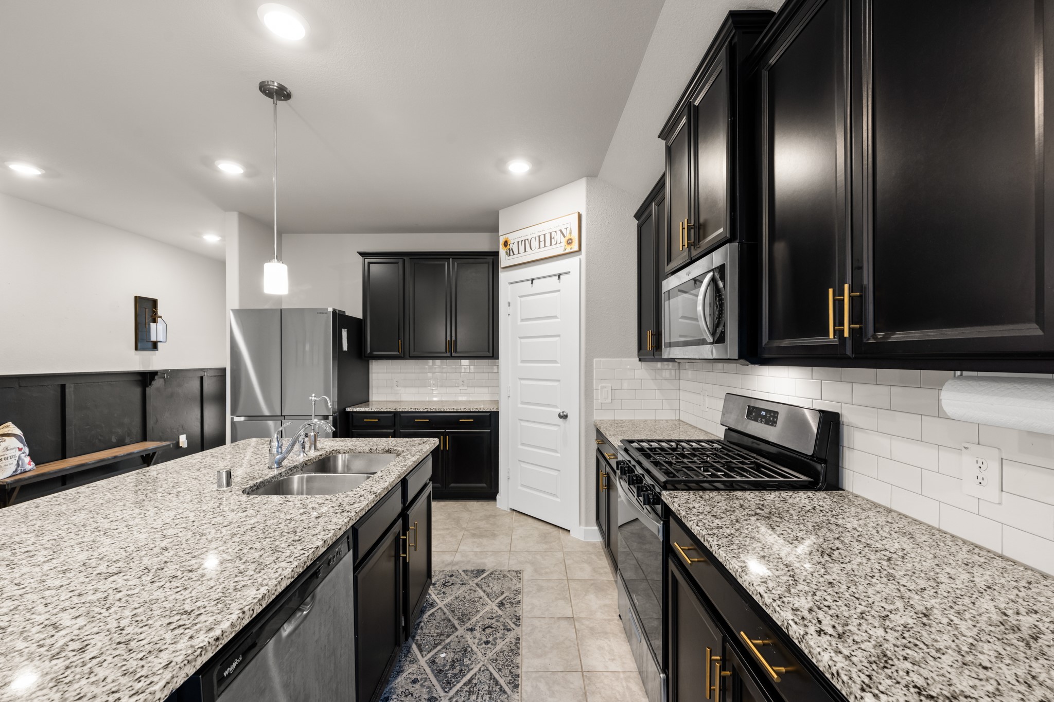 1326 Taft Pt Lane Rosharon, TX 77583 - Photo 10 of 39 a kitchen with granite countertop kitchen island stainless steel appliances sink stove microwave and cabinets