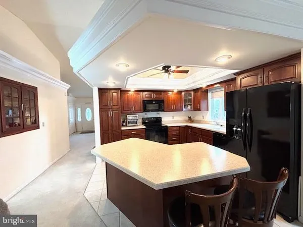 a large kitchen with a table and chairs
