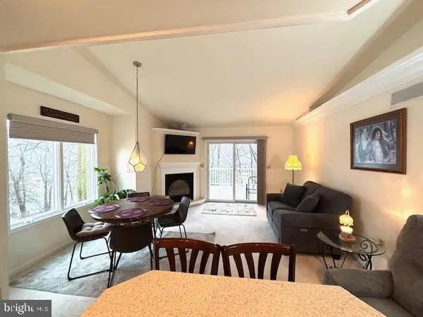 a living room with furniture a fireplace and a table