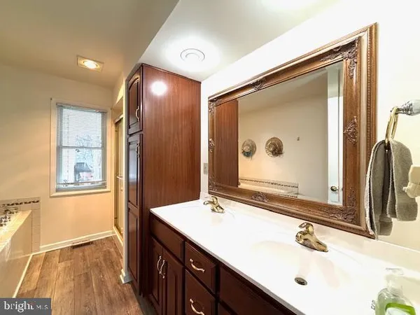 a bathroom with a double vanity sink and a mirror