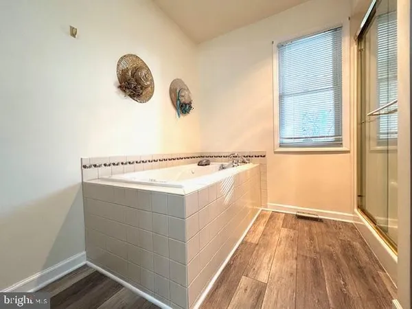a view of a kitchen with wooden floor and a window