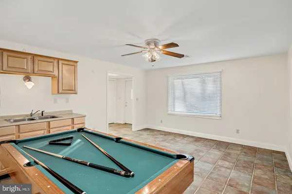 a room with pool table and windows