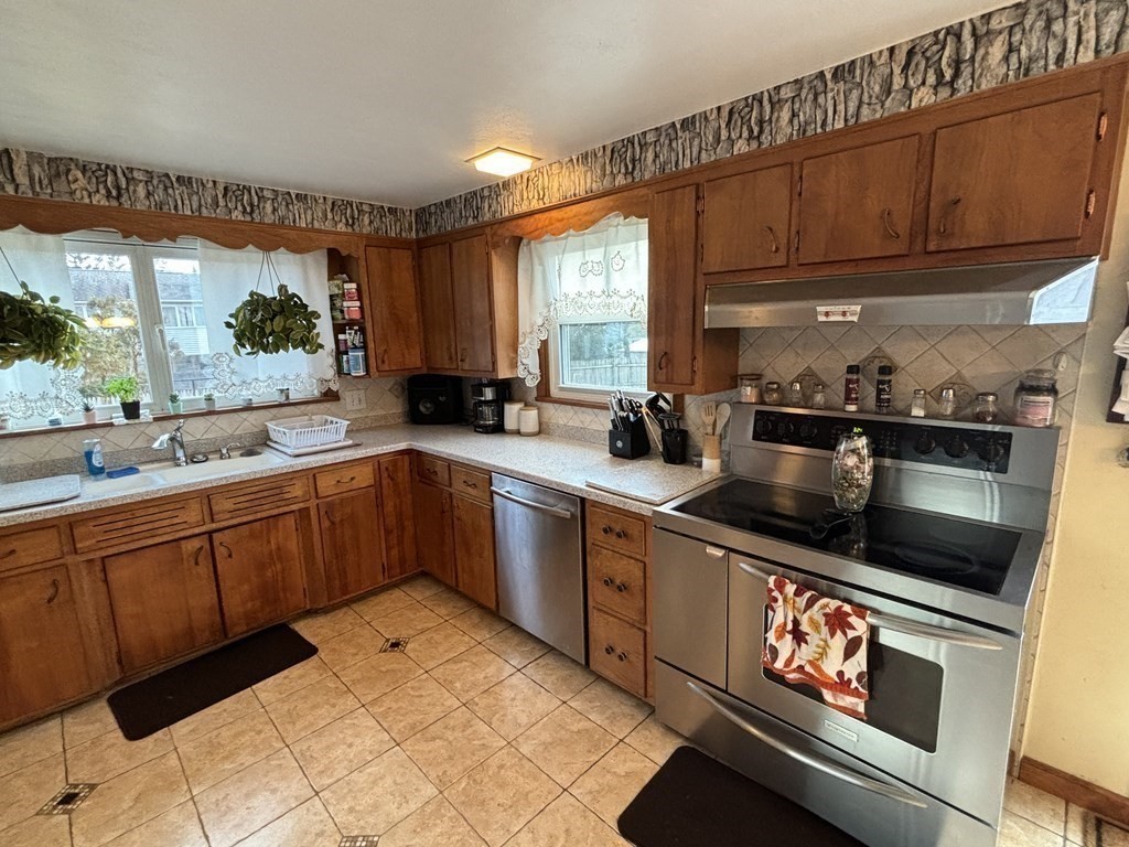 394 Granby Road Chicopee, MA 01013 - Photo 16 of 38 a kitchen with stainless steel appliances kitchen island granite countertop a sink and cabinets
