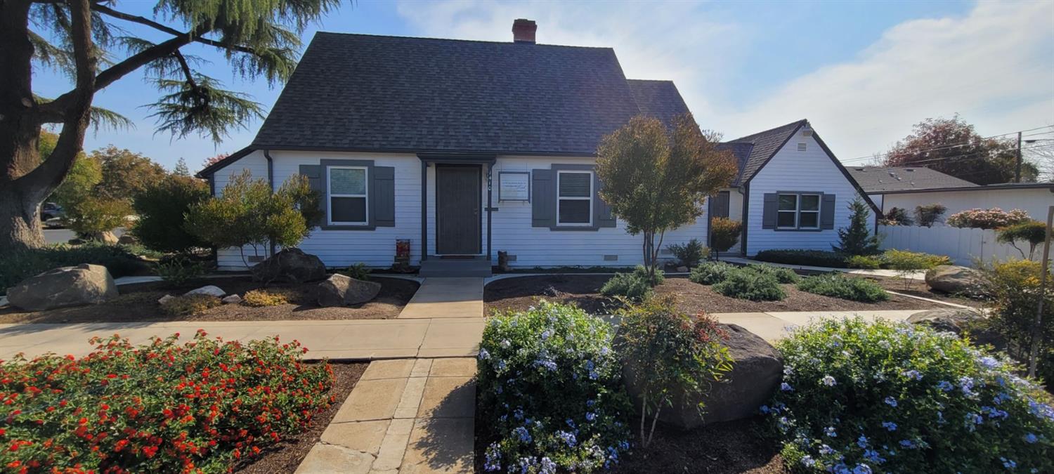 1410 10th Street Reedley, CA 93654 - Photo 2 of 44 a front view of a house with a yard