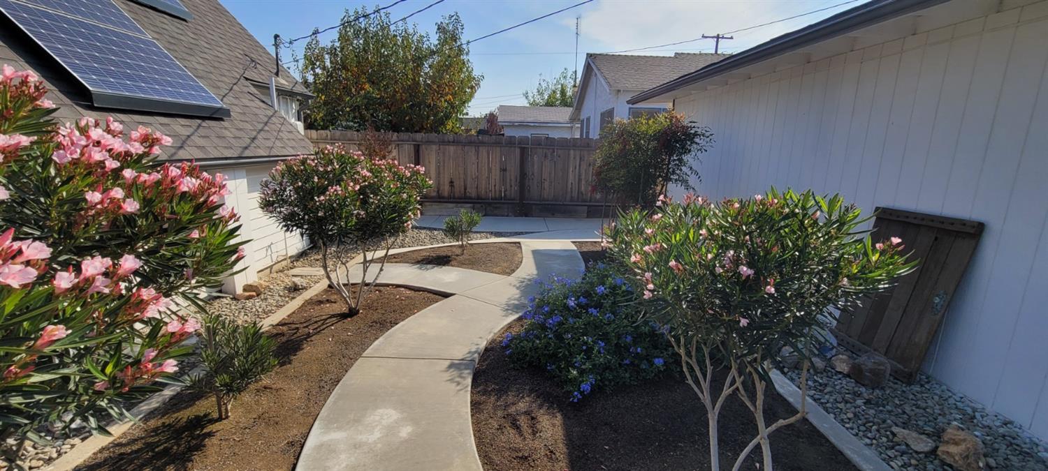 1410 10th Street Reedley, CA 93654 - Photo 11 of 44 a view of a backyard with flowers
