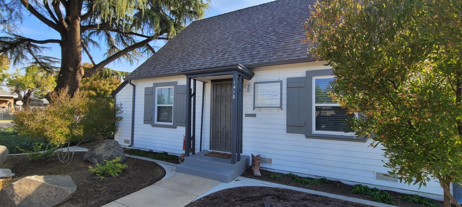 1410 10th Street Reedley, CA 93654 - Photo 13 of 44 a front view of a house with garden