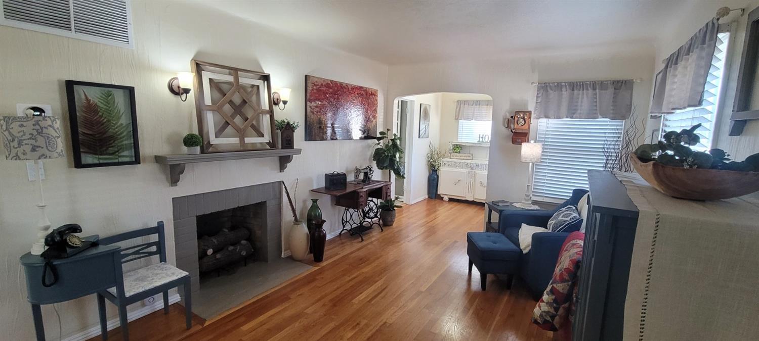 1410 10th Street Reedley, CA 93654 - Photo 15 of 44 a living room with furniture and a fireplace
