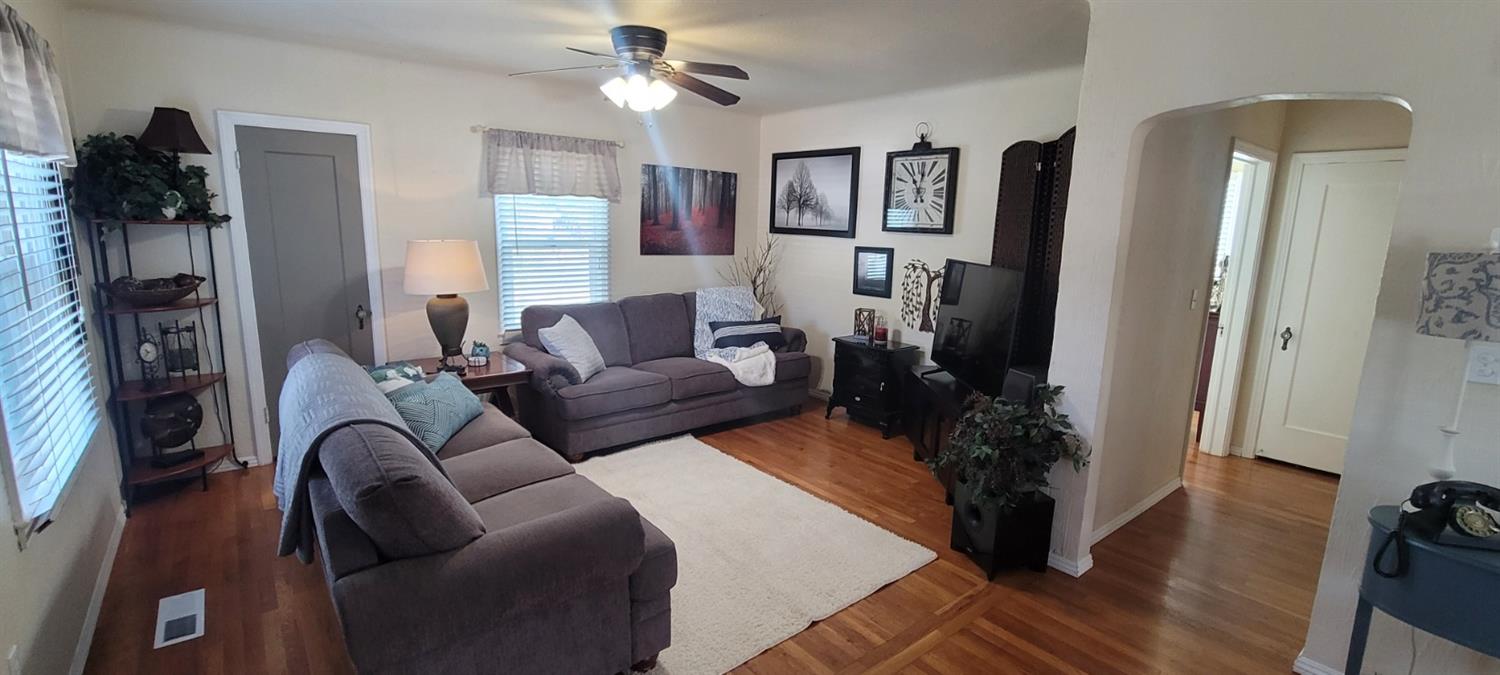 1410 10th Street Reedley, CA 93654 - Photo 17 of 44 a living room with furniture and a window