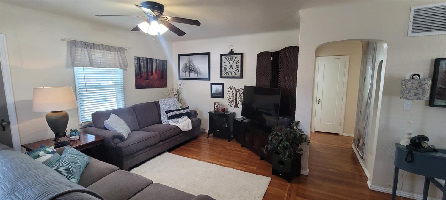 1410 10th Street Reedley, CA 93654 - Photo 18 of 44 a living room with furniture and wooden floor