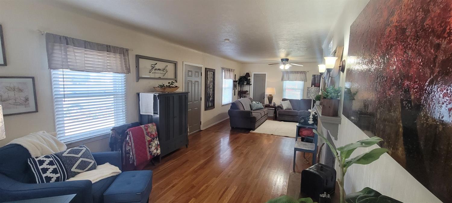1410 10th Street Reedley, CA 93654 - Photo 20 of 44 a living room with furniture and wooden floor