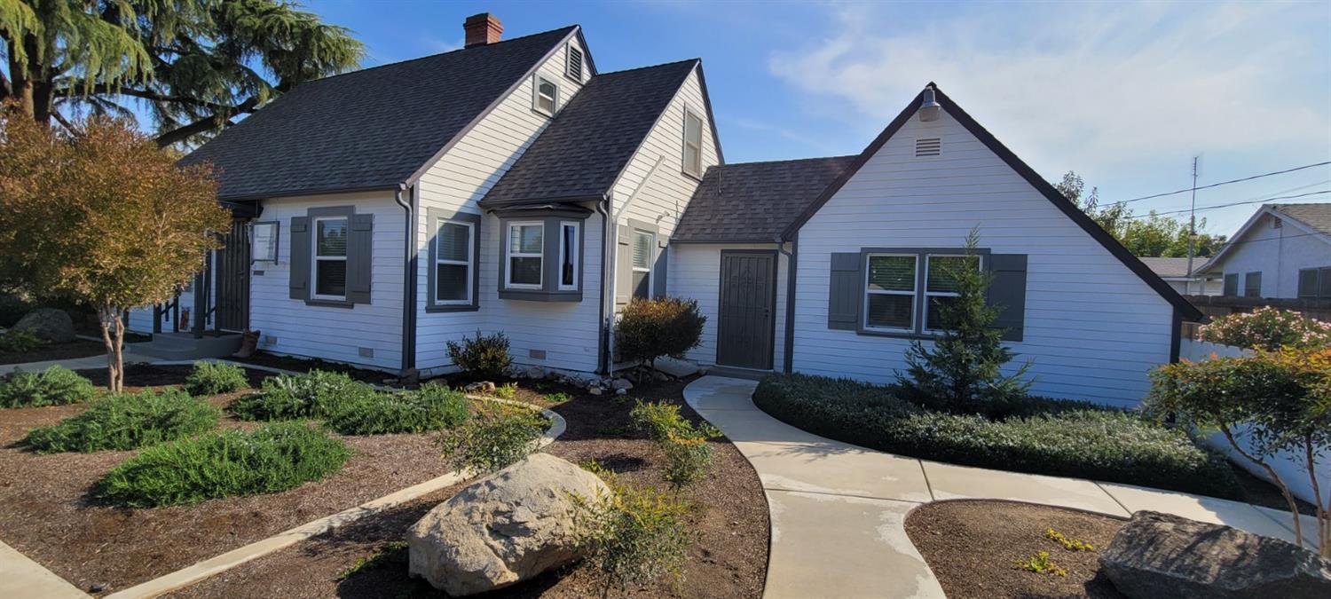 1410 10th Street Reedley, CA 93654 - Photo 3 of 44 a front view of a house with a yard