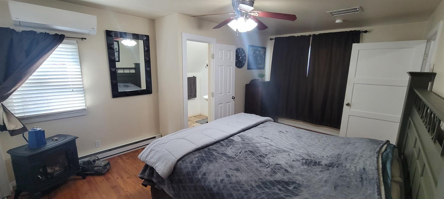 1410 10th Street Reedley, CA 93654 - Photo 22 of 44 a bedroom with a bed and a dresser