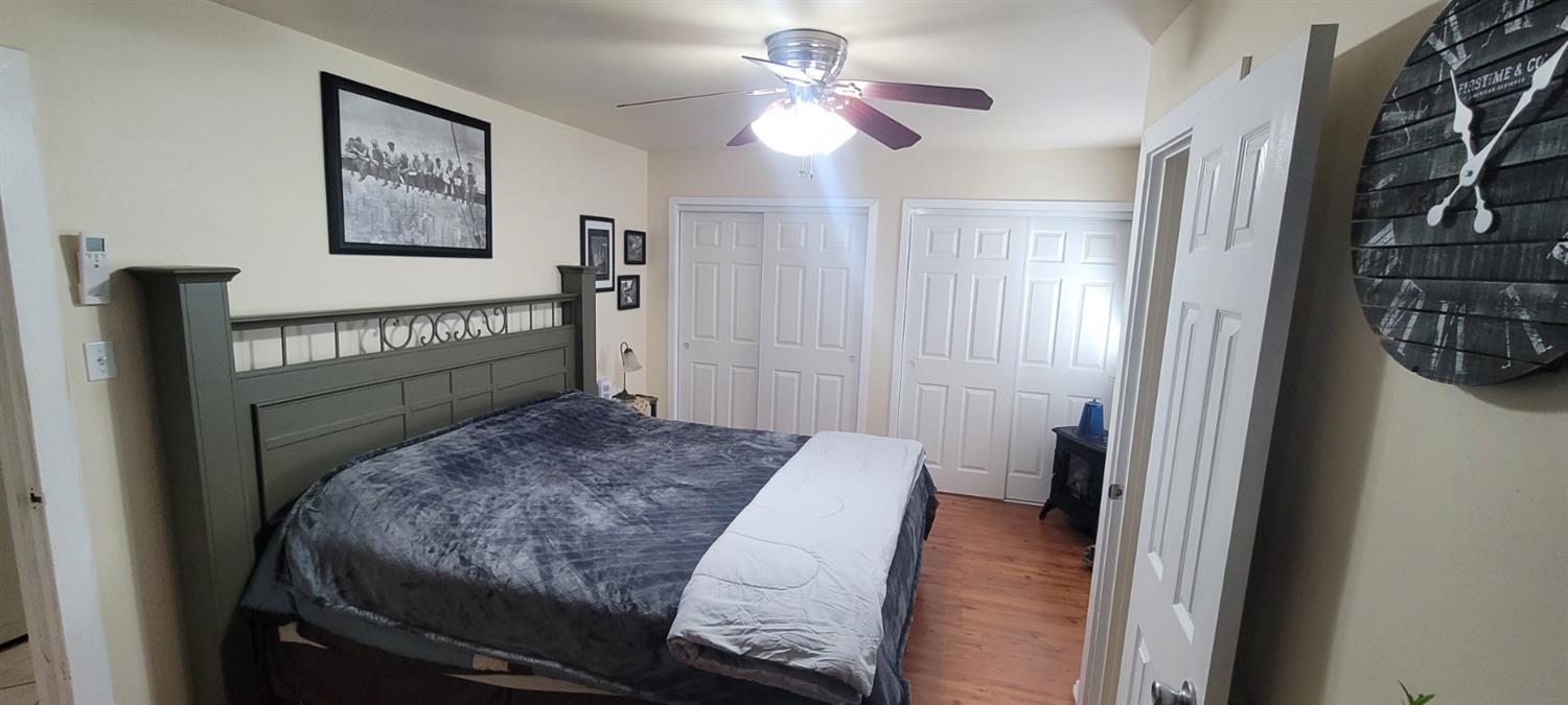 1410 10th Street Reedley, CA 93654 - Photo 25 of 44 a bedroom with a bed and a chandelier