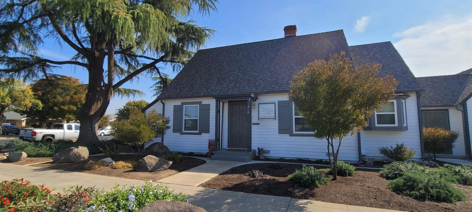 1410 10th Street Reedley, CA 93654 - Photo 4 of 44 a front view of a house with a yard