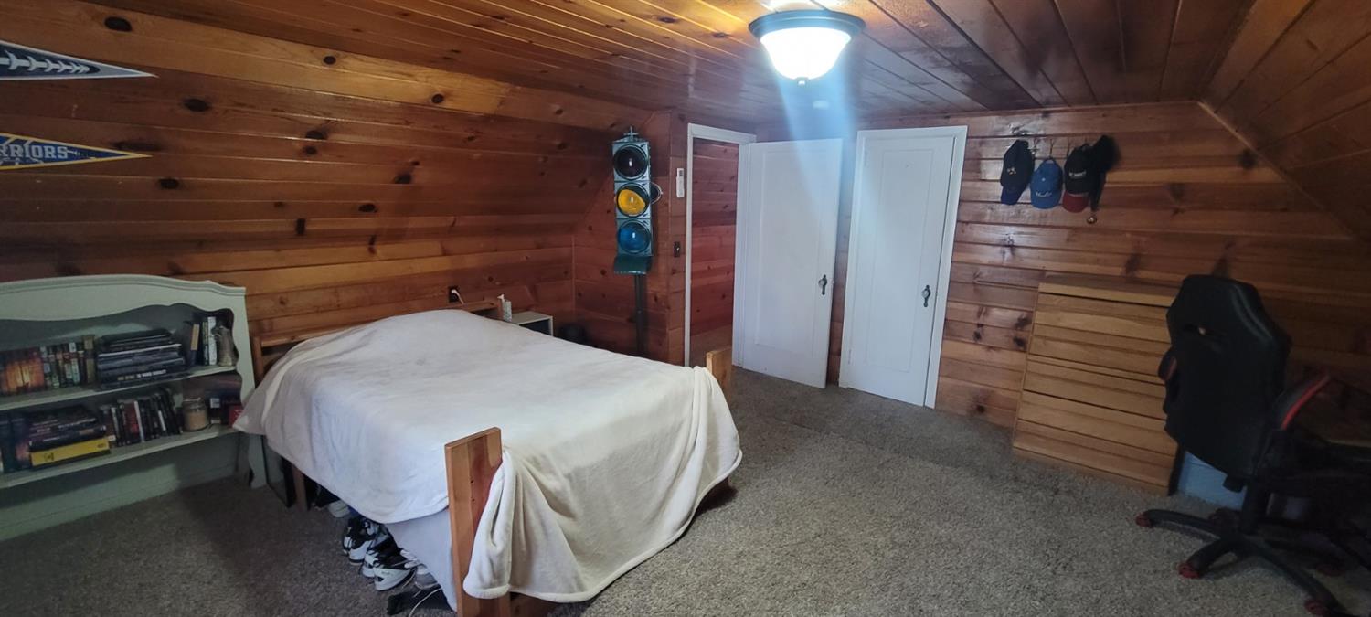 1410 10th Street Reedley, CA 93654 - Photo 36 of 44 a bedroom with a bed and a desk
