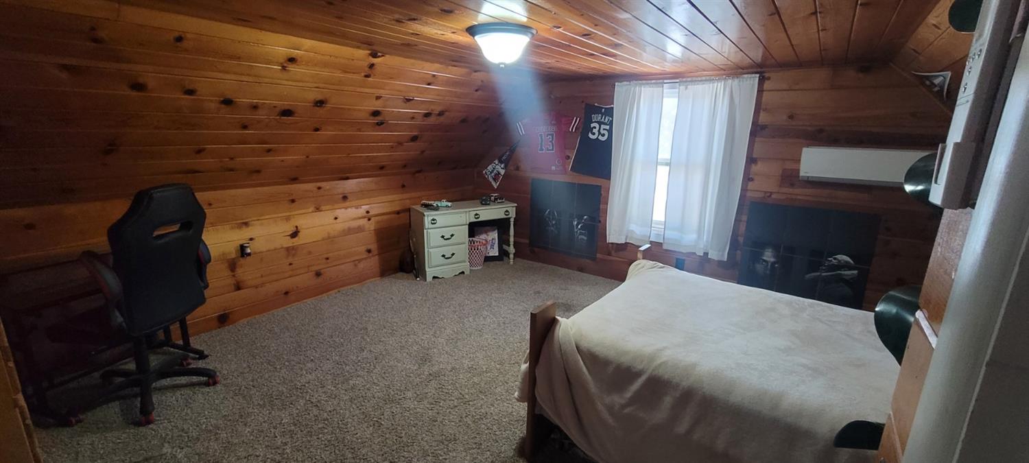 1410 10th Street Reedley, CA 93654 - Photo 37 of 44 a bed room with a bed and a chair