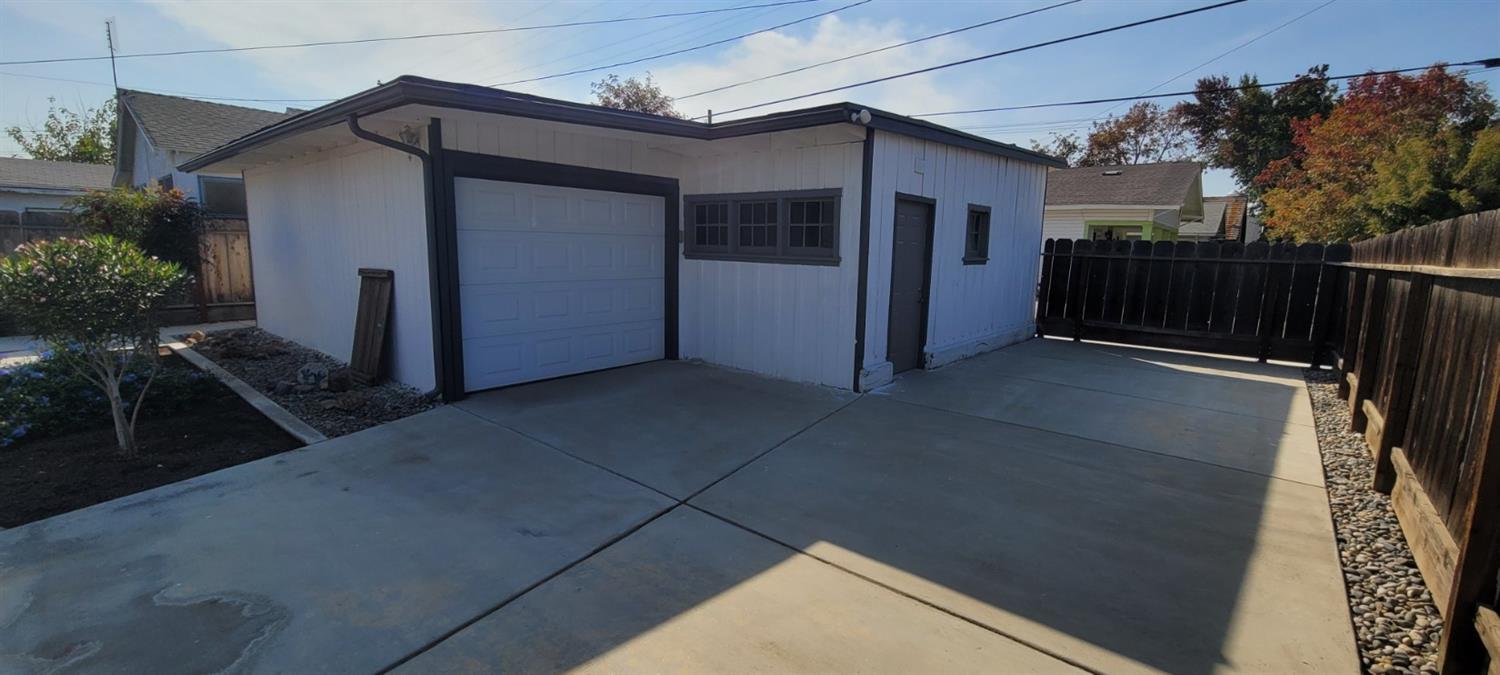 1410 10th Street Reedley, CA 93654 - Photo 8 of 44 a view of a house with a garage