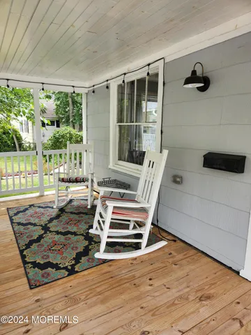 a view of a living room and floor to ceiling window or wooden floor