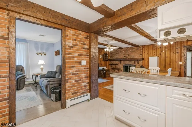 a view of living room with furniture and a ceiling fan