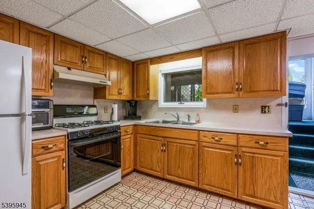 a kitchen with cabinets a sink and appliances