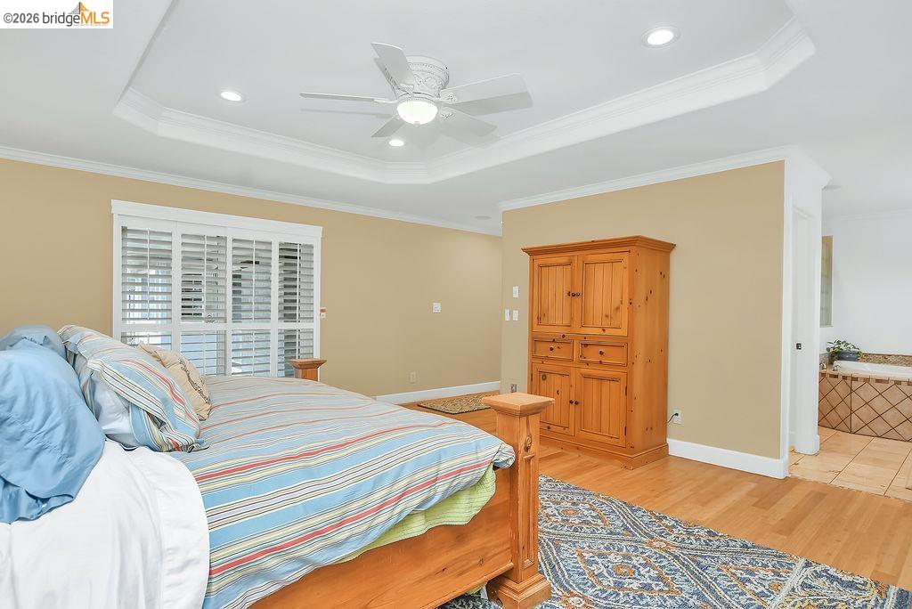 4190 Brown Road Oakley, CA 94561 - Photo 23 of 33 Bedroom with light wood-type flooring, ornamental molding, a tray ceiling, ceiling fan, and recessed lighting