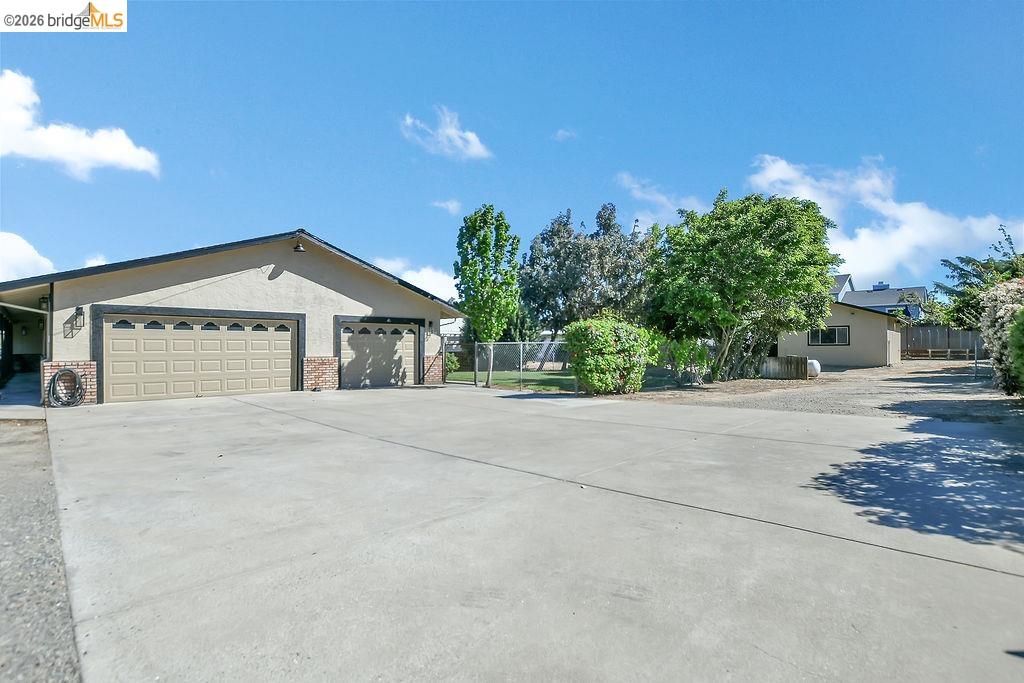 4190 Brown Road Oakley, CA 94561 - Photo 27 of 33 Ranch-style home featuring brick siding, driveway, stucco siding, an attached garage, and a gate