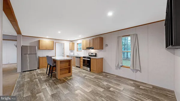 a view of kitchen with refrigerator stove microwave and cabinets