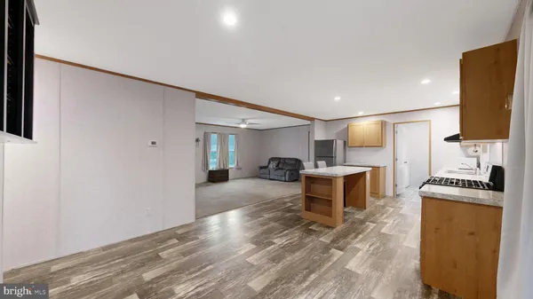a kitchen with a refrigerator and a stove top oven