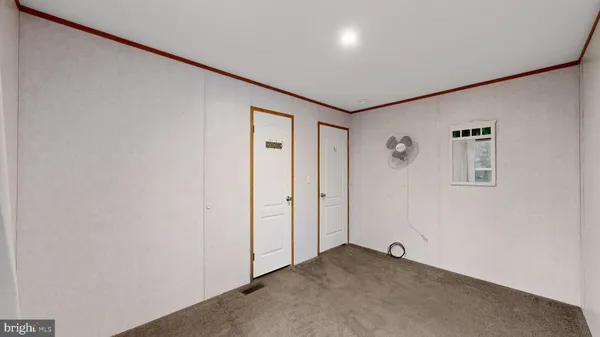 a view of a livingroom with an empty space and a window