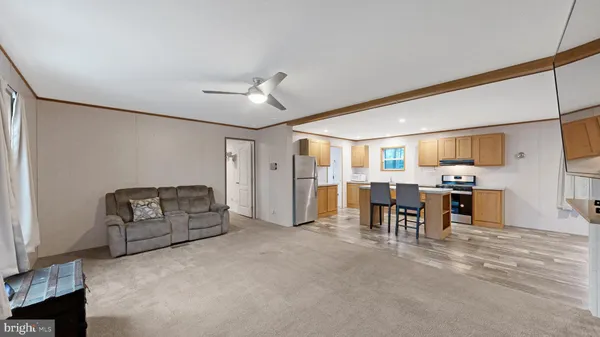 a living room with furniture and a dining table