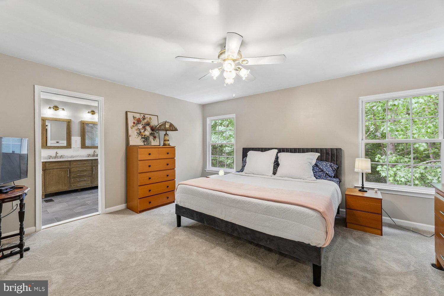 3707 Turn Back Trail Triangle, VA 22172 - Photo 28 of 55 a bedroom with a bed and a chandelier