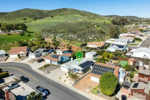 an aerial view of residential houses with outdoor space